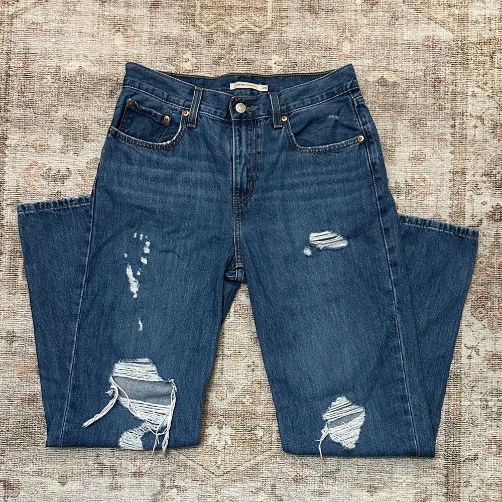 Woman’s Dark Blue Distressed Levi’s Low Pro Straight
